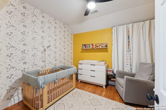 2047 Thicket Trail Dr, San Antonio, TX 78248 - bedroom featuring visible vents, a crib, wood finished floors, and wallpapered walls