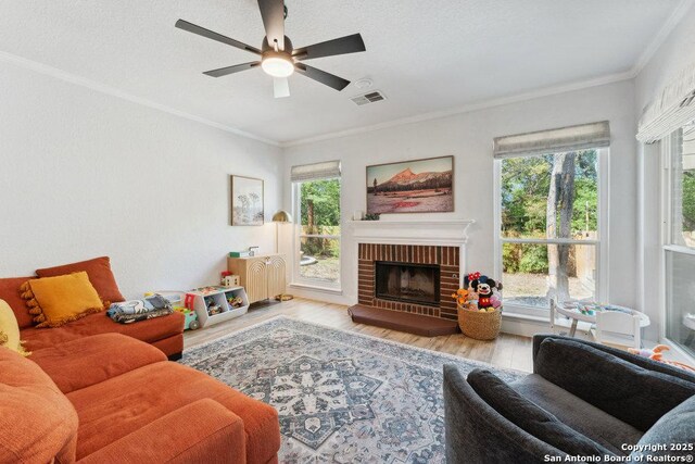 2047 Thicket Trail Dr, San Antonio, TX 78248 - living room with visible vents, ceiling fan, a fireplace, crown molding, and wood finished floors