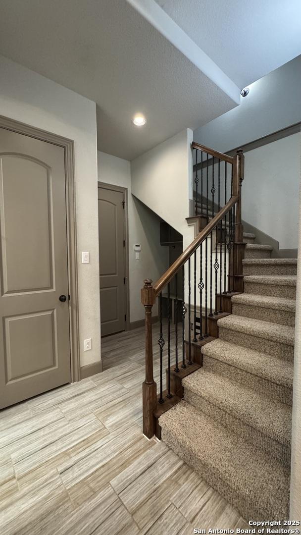 staircase with recessed lighting