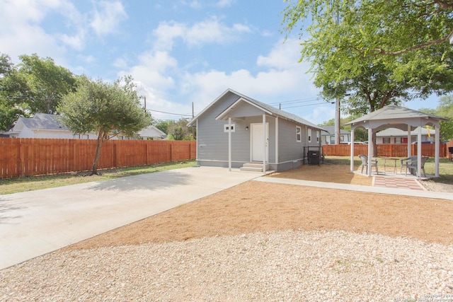 garage featuring concrete driveway and fence