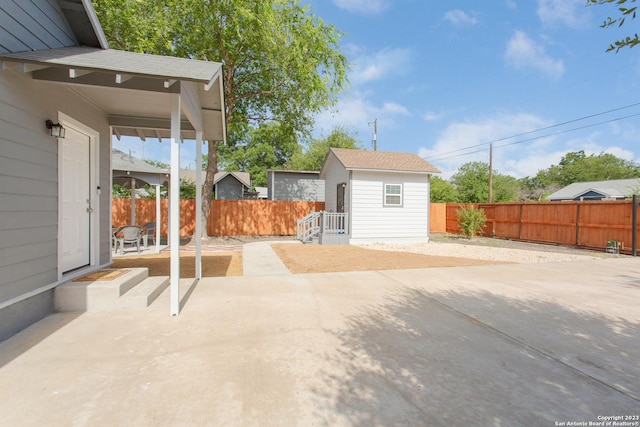view of patio / terrace featuring an outbuilding and a fenced backyard