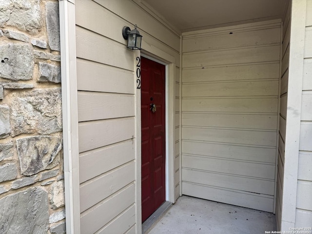 property entrance with stone siding