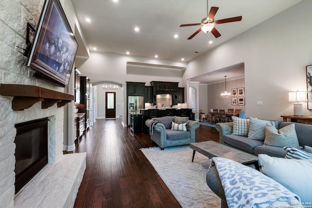 4111 Monteverde Run, San Antonio, TX 78261 - living room with ceiling fan with notable chandelier, a fireplace, dark wood-type flooring, recessed lighting, and a high ceiling