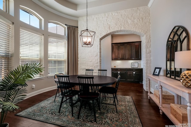 4111 Monteverde Run, San Antonio, TX 78261 - dining space featuring plenty of natural light, a notable chandelier, a towering ceiling, and dark wood finished floors