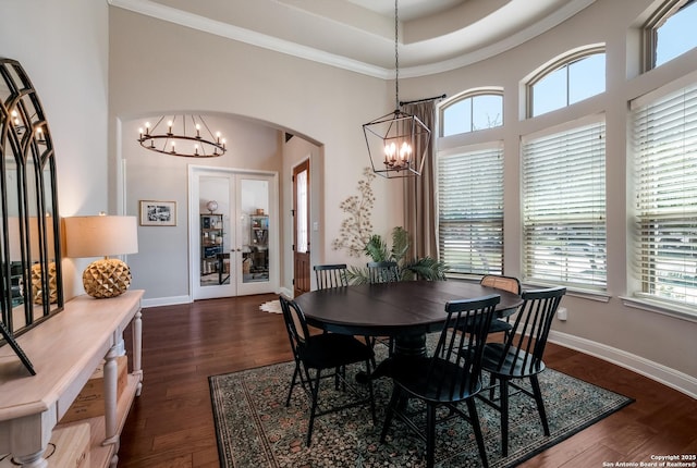 4111 Monteverde Run, San Antonio, TX 78261 - dining area with a chandelier, arched walkways, a towering ceiling, and dark wood-style floors