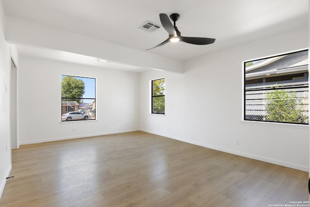 unfurnished room featuring visible vents, baseboards, a ceiling fan, and light wood-type flooring