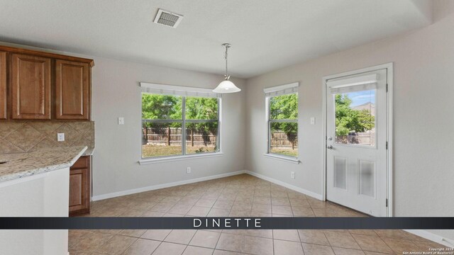 2441 Ibis, New Braunfels, TX 78130 - unfurnished dining area featuring light tile patterned floors, visible vents, and baseboards