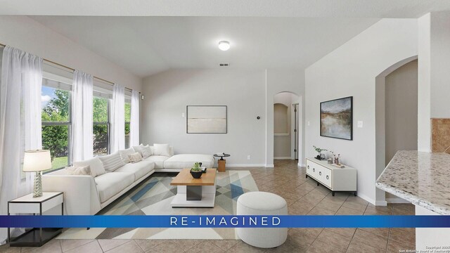 2441 Ibis, New Braunfels, TX 78130 - tiled living area featuring arched walkways, visible vents, baseboards, and lofted ceiling