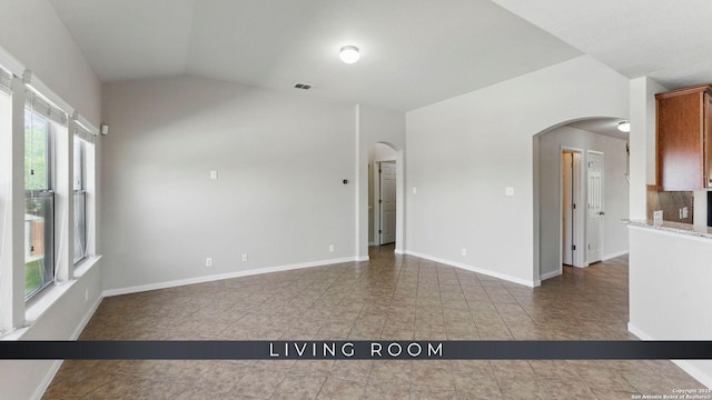 2441 Ibis, New Braunfels, TX 78130 - unfurnished room with visible vents, arched walkways, tile patterned flooring, and lofted ceiling