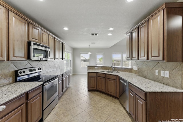 2441 Ibis, New Braunfels, TX 78130 - kitchen with a peninsula, visible vents, recessed lighting, appliances with stainless steel finishes, and a sink