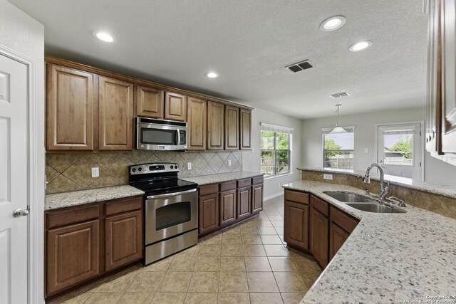 2441 Ibis, New Braunfels, TX 78130 - kitchen featuring recessed lighting, visible vents, decorative backsplash, stainless steel appliances, and a sink