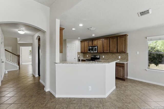 2441 Ibis, New Braunfels, TX 78130 - kitchen with visible vents, light tile patterned floors, a sink, stainless steel appliances, and decorative backsplash