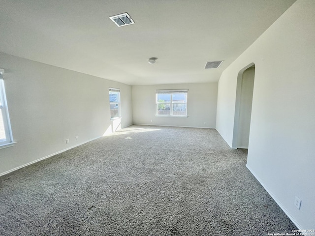 8131 Falcon Mdw, Converse, TX 78109 - unfurnished room featuring visible vents, arched walkways, and carpet flooring