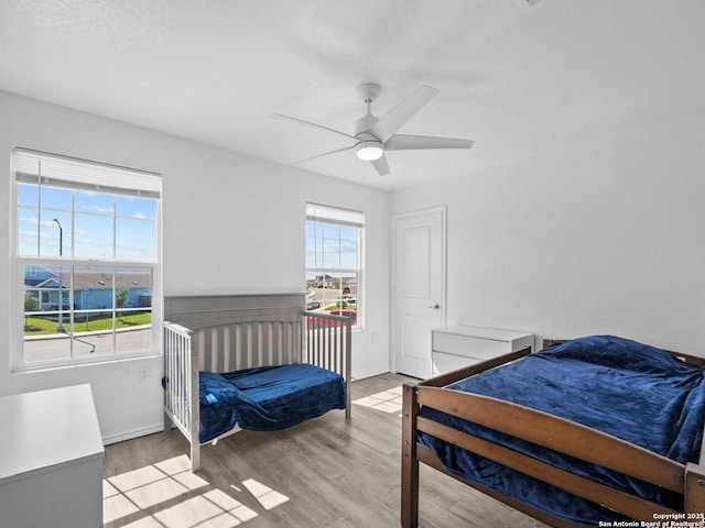 603 Vermilion, San Antonio, TX 78221 - bedroom featuring baseboards, light wood-type flooring, and a ceiling fan