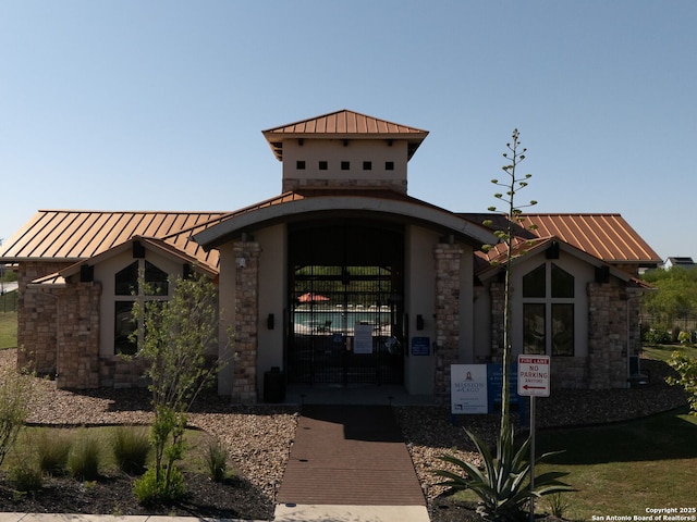 603 Vermilion, San Antonio, TX 78221 - exterior space with metal roof, stone siding, a standing seam roof, and a gate