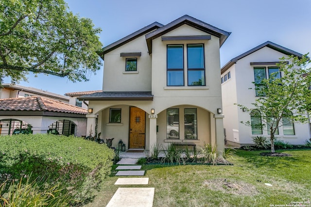 432 E Olmos, San Antonio, TX 78212 - mediterranean / spanish house featuring a front lawn, covered porch, and stucco siding