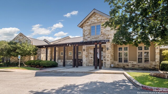 1147 Andean Emerald, San Antonio, TX 78253 - view of front facade featuring a standing seam roof, stone siding, and metal roof