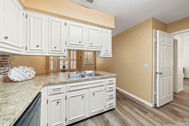 5359 Fredericksburg Rd Unit 808, San Antonio, TX 78229 - kitchen with white cabinets, dishwasher, wood finished floors, and a sink