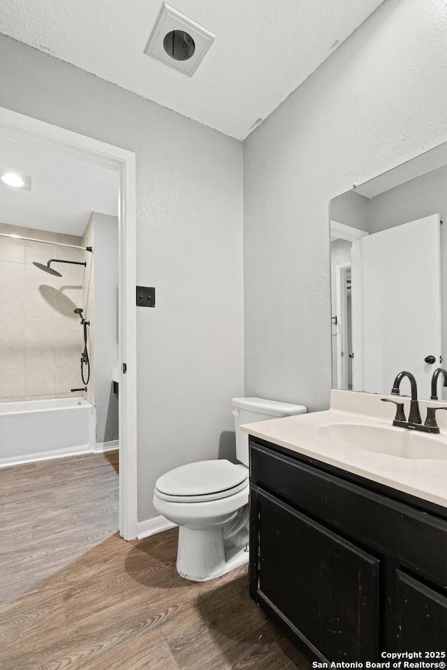 5454 Vista Ct, San Antonio, TX 78247 - bathroom featuring toilet, wood finished floors, vanity, and bathing tub / shower combination