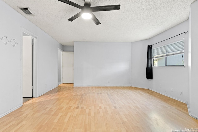 5454 Vista Ct, San Antonio, TX 78247 - unfurnished room with ceiling fan, a textured ceiling, visible vents, wood finished floors, and baseboards