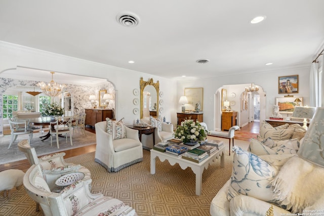 643 Terrell Rd, Terrell Hills, TX 78209 - living area featuring arched walkways, a chandelier, crown molding, wood finished floors, and recessed lighting
