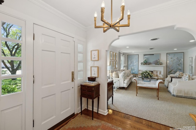 643 Terrell Rd, Terrell Hills, TX 78209 - entrance foyer featuring arched walkways, a chandelier, wood finished floors, and crown molding