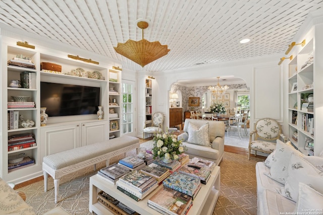 643 Terrell Rd, Terrell Hills, TX 78209 - living area with arched walkways, a chandelier, built in features, and ornamental molding