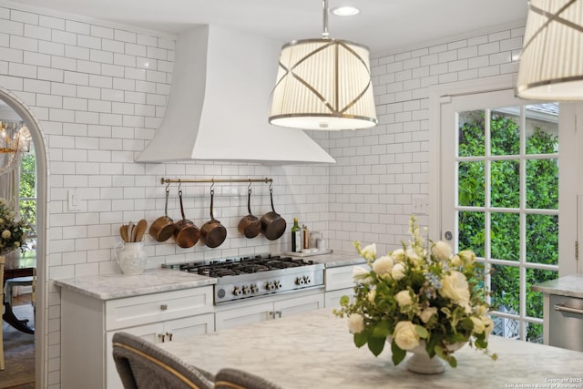 643 Terrell Rd, Terrell Hills, TX 78209 - kitchen featuring appliances with stainless steel finishes, backsplash, custom exhaust hood, and light stone counters