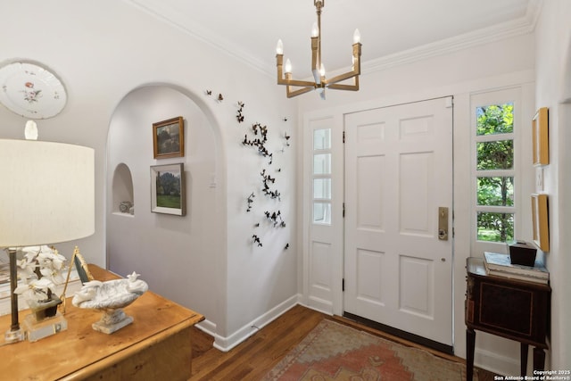 643 Terrell Rd, Terrell Hills, TX 78209 - entryway with crown molding, wood finished floors, arched walkways, a chandelier, and baseboards
