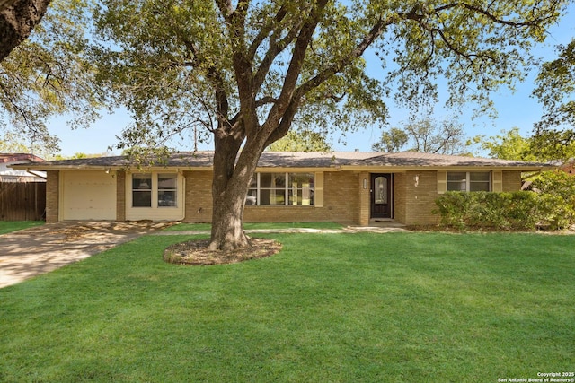 ranch-style home featuring a garage, brick siding, a front lawn, and concrete driveway