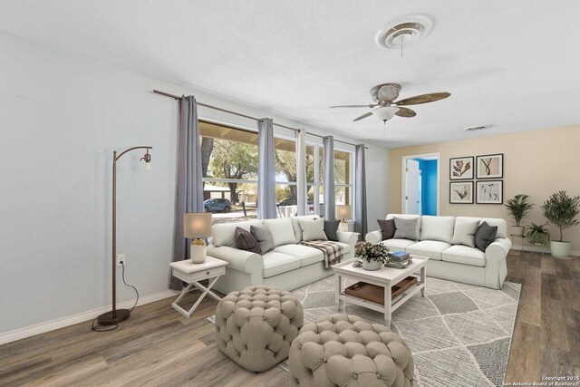 living room featuring ceiling fan, baseboards, wood finished floors, and visible vents