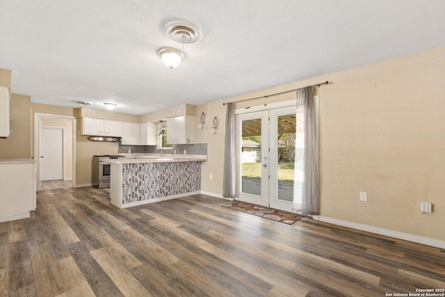 kitchen featuring under cabinet range hood, dark wood-style flooring, french doors, and stainless steel gas stove