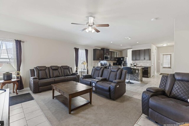 8018 Radiant Sunset, San Antonio, TX 78252 - living room featuring light tile patterned floors, baseboards, and a ceiling fan