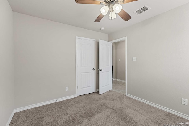 8018 Radiant Sunset, San Antonio, TX 78252 - unfurnished bedroom featuring visible vents, baseboards, a ceiling fan, and light colored carpet