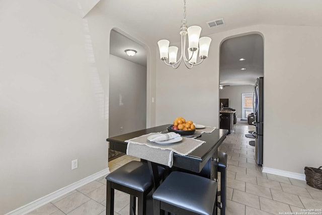 8018 Radiant Sunset, San Antonio, TX 78252 - dining room with arched walkways, an inviting chandelier, visible vents, and light tile patterned floors
