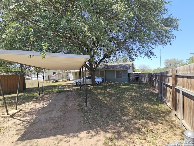 390 Harcourt, San Antonio, TX 78223 - view of yard featuring fence private yard and a detached carport