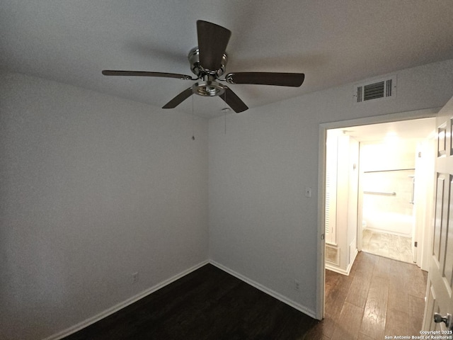 390 Harcourt, San Antonio, TX 78223 - empty room with baseboards, visible vents, dark wood-style flooring, and a ceiling fan