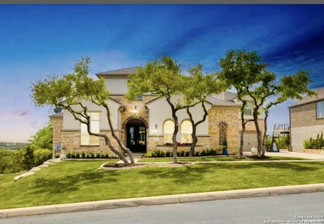 8118 Vanity, San Antonio, TX 78256 - view of front of home with a front yard, french doors, stone siding, and stucco siding