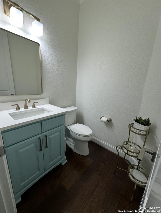 8118 Vanity, San Antonio, TX 78256 - half bathroom featuring toilet, vanity, wood finished floors, and baseboards