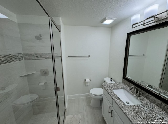 8118 Vanity, San Antonio, TX 78256 - bathroom featuring vanity, a stall shower, a textured ceiling, and toilet