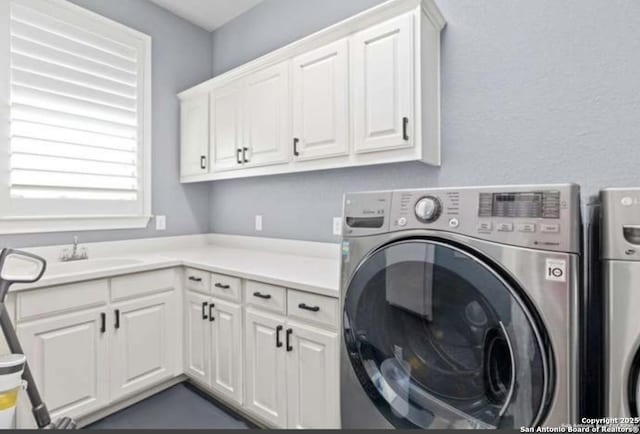 8118 Vanity, San Antonio, TX 78256 - washroom featuring washer and clothes dryer, a sink, and cabinet space