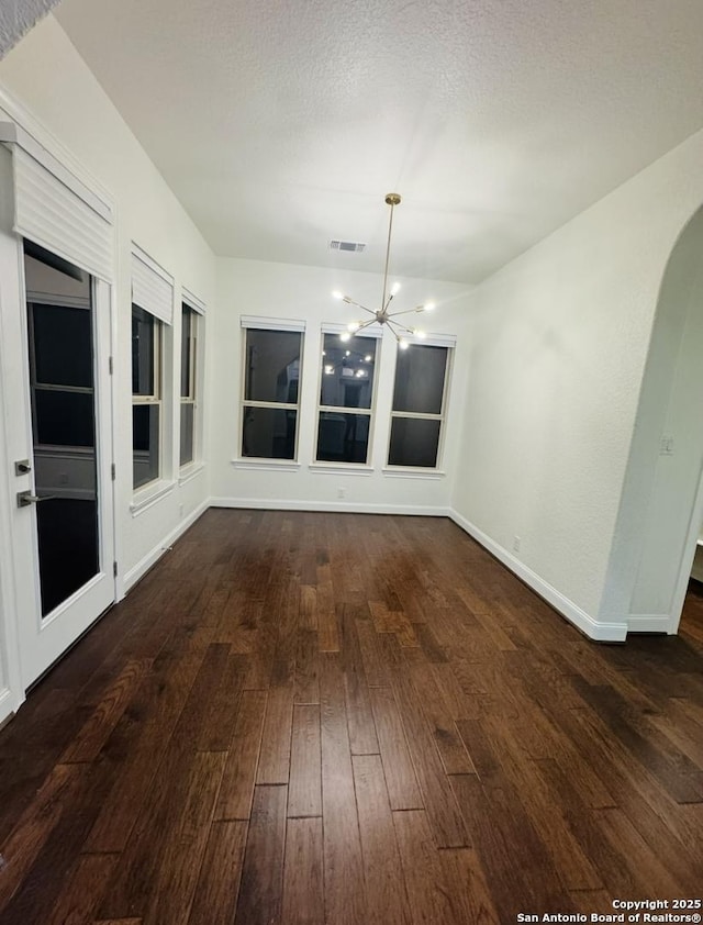 8118 Vanity, San Antonio, TX 78256 - unfurnished dining area with baseboards, hardwood / wood-style floors, a notable chandelier, and visible vents