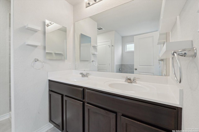 13506 Whisper Bnd, San Antonio, TX 78252 - full bathroom with a sink, visible vents, baseboards, and double vanity