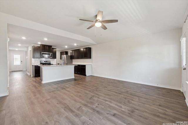 13506 Whisper Bnd, San Antonio, TX 78252 - unfurnished living room featuring wood finished floors, ceiling fan, baseboards, and recessed lighting