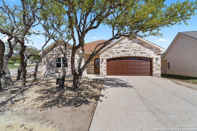 2108 Athens Ave, Kerrville, TX 78028 - view of front of property featuring an attached garage, stone siding, and driveway
