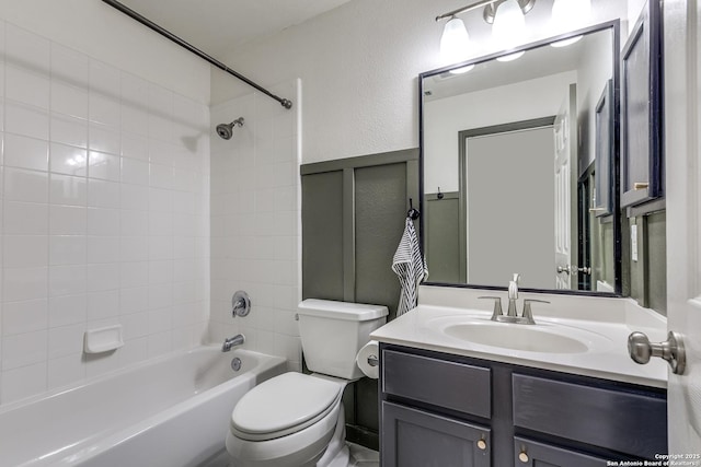 full bath featuring toilet, vanity, shower / bathing tub combination, and wainscoting