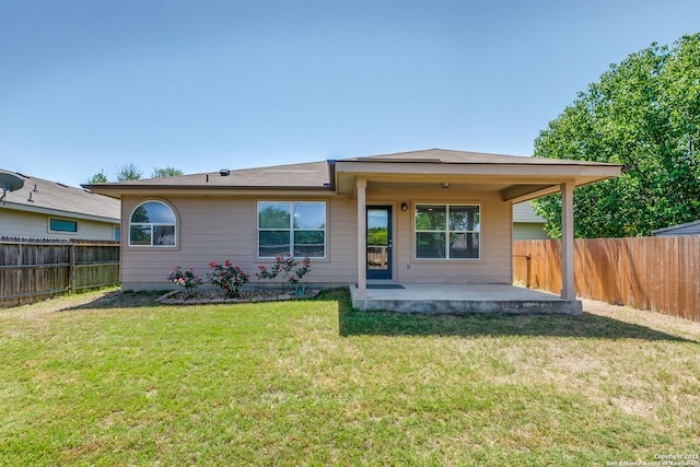 back of house with a patio area, a fenced backyard, and a yard