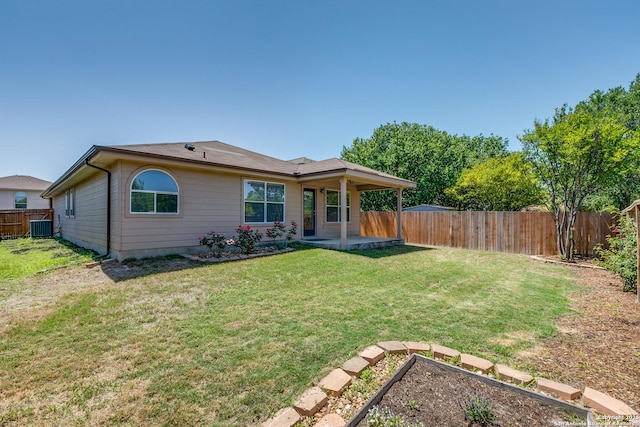 rear view of house with central AC unit, a yard, a patio area, a vegetable garden, and a fenced backyard