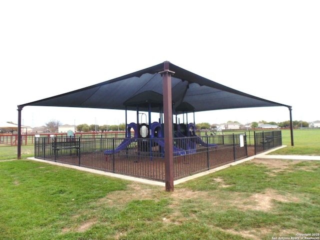 communal playground with a yard and fence