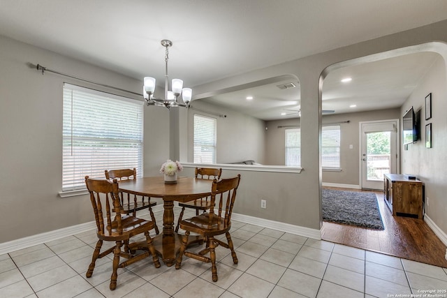 dining area with recessed lighting, plenty of natural light, light tile patterned floors, and ceiling fan with notable chandelier